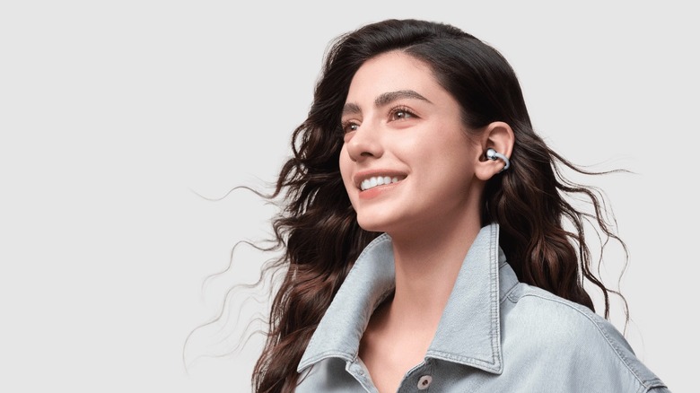 Person wearing HUAWEI clip-on earbuds