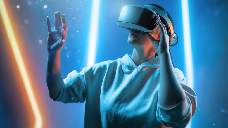 A person wearing a VR headset against a background with an abstract light graphic