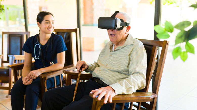 An elderly man looking excited while wearing a VR headset