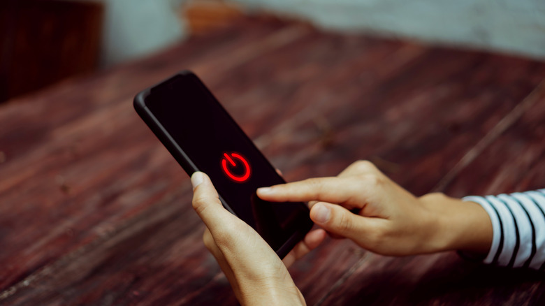 Person turning phone off