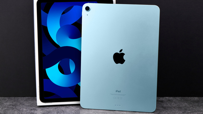 Blue Apple iPad Air (2022) with a box against a dark background