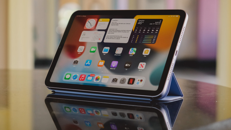 The Apple iPad mini 6 propped up using the folio case on a table