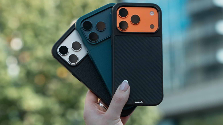 Three phones with Mous cases held one hand