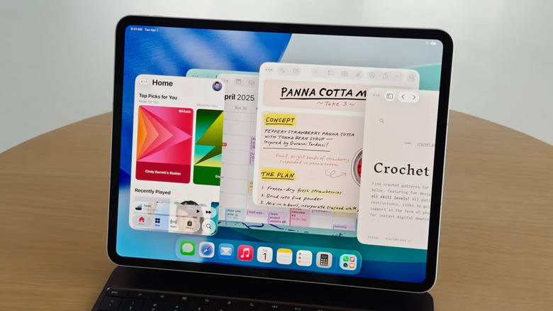 iPad connected to keyboard showing many apps open