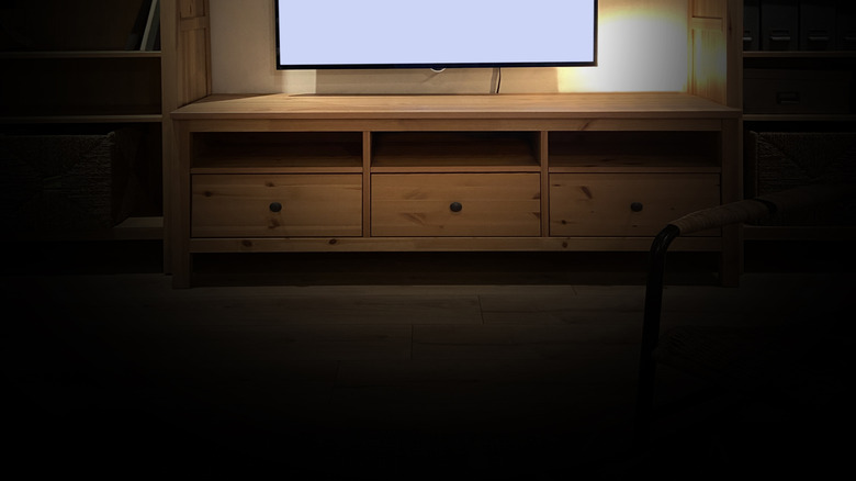 A TV with a blank white screen and dim brightness level