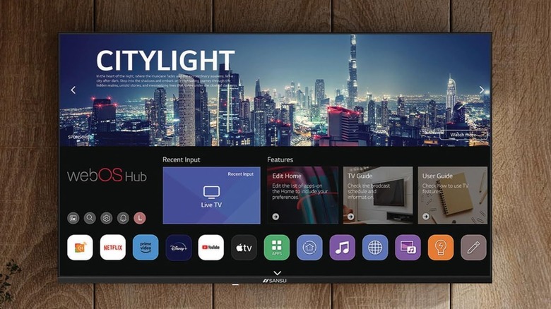 A promotional image for the Sansui 32-inch VA Series Full HD Frameless Smart TV, the image depicts the TV hanging on a wall as it displays the home screen for webOS