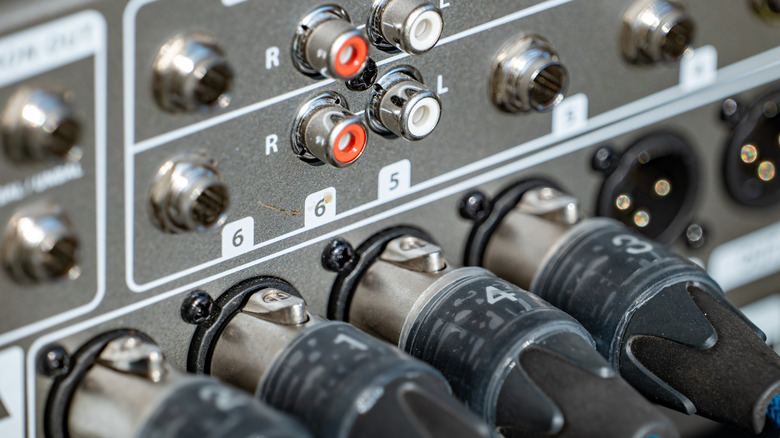 Close-up of professional sound panel with cables plugged in