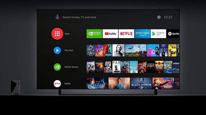 Nvidia Shield TV Pro next to TV showing Android TV UI on screen