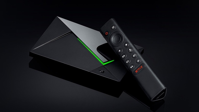 Nvidia Shield TV Pro against black background showing lit remote and LED stripe on box