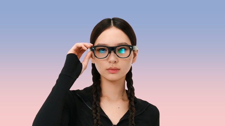 A person wearing RayNeo's X3 Pro AR glasses against a gradient background