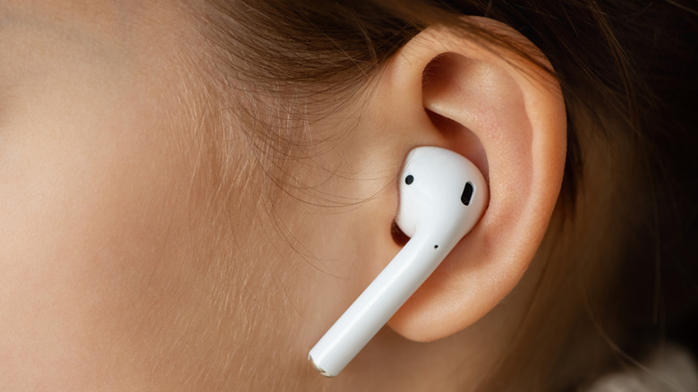Close-up of earbud in woman's ear