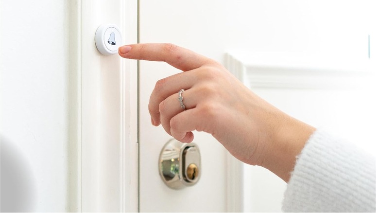 Flic Smart Button about to be pressed by a finger