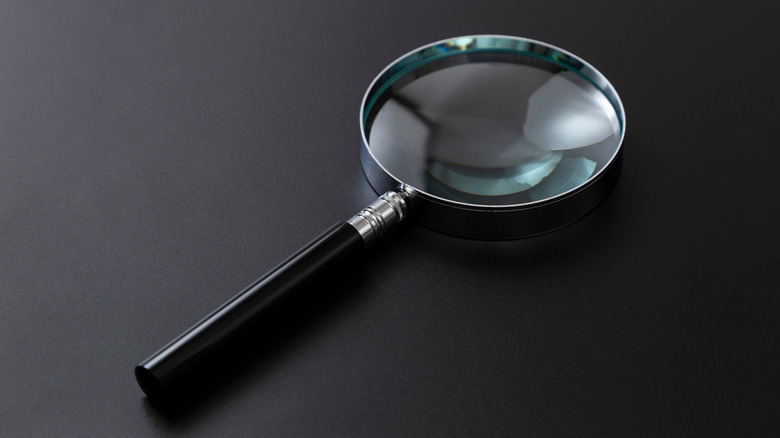 Magnifying glass on dark table