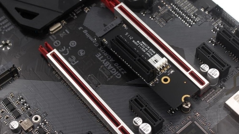 A Gigabyte motherboard with a PCIe adapter plugged into an M.2 slot