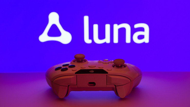 Close-up of a white gamepad with the Amazon Luna text and logo in the background