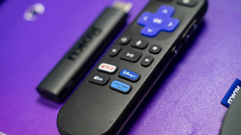 A close-up shot of the Roku TV Voice Remote and the Roku Streaming Stick