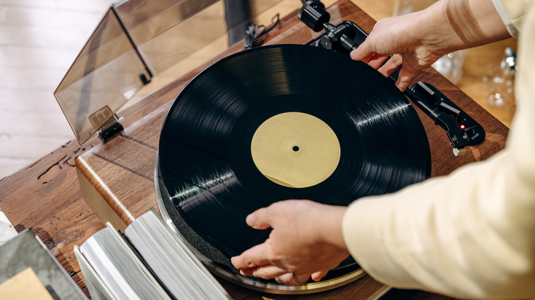 A person putting record on record player