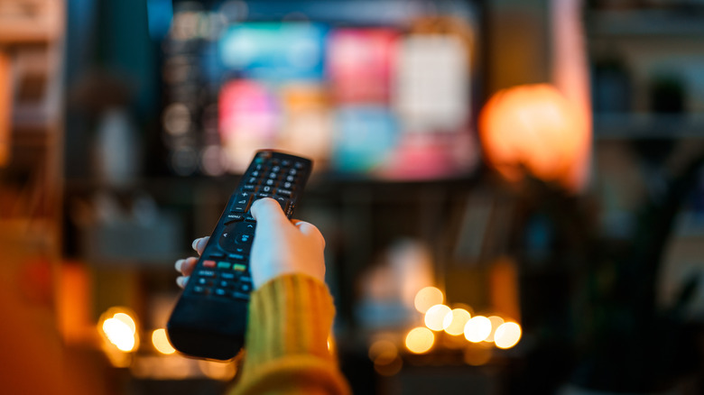 A close-up of a person using a remote control