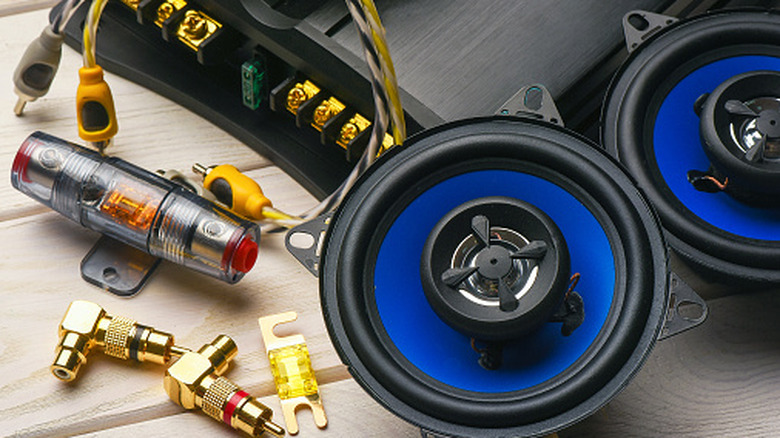 Parts of a car's speaker system disassembled on a table.