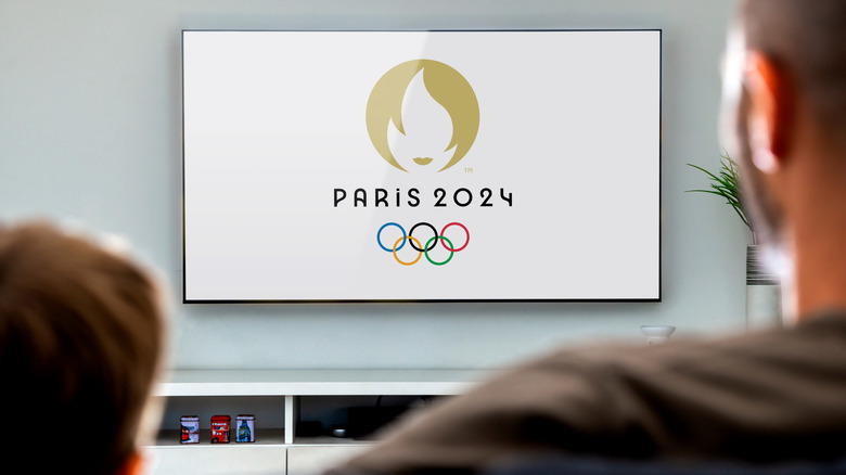 Two people watching the Paris 2024 Olympics on a Smart TV
