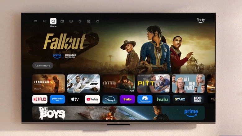 An Amazon Fire TV mounted on the wall with its home screen being displayed