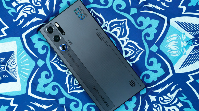 RedMagic gaming phone lying face down on a blue patterned surface.