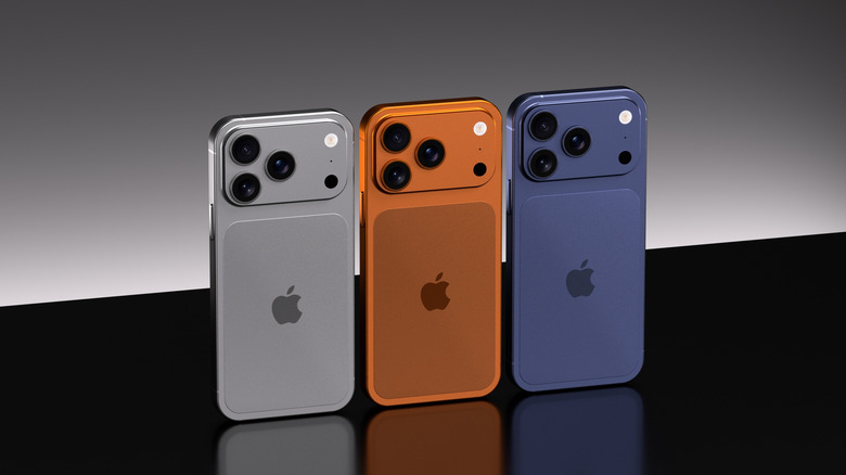 Three differently colored iPhone 17 Pro phones standing side by side