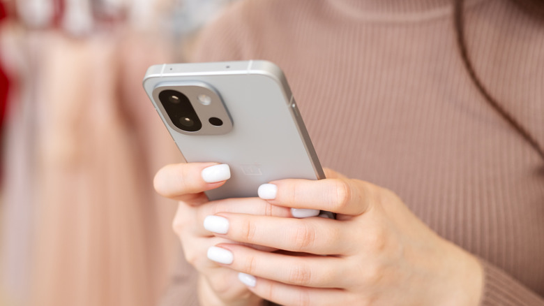 Person holding a OnePlus smartphone