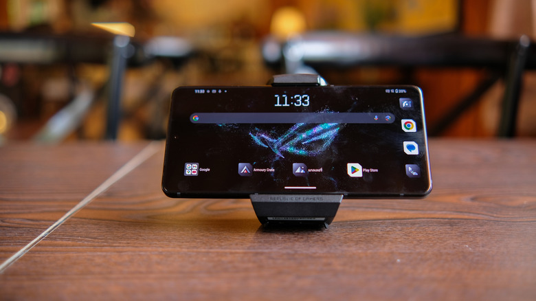 ASUS ROG Phone 9 Pro with stand on a table and screen visible