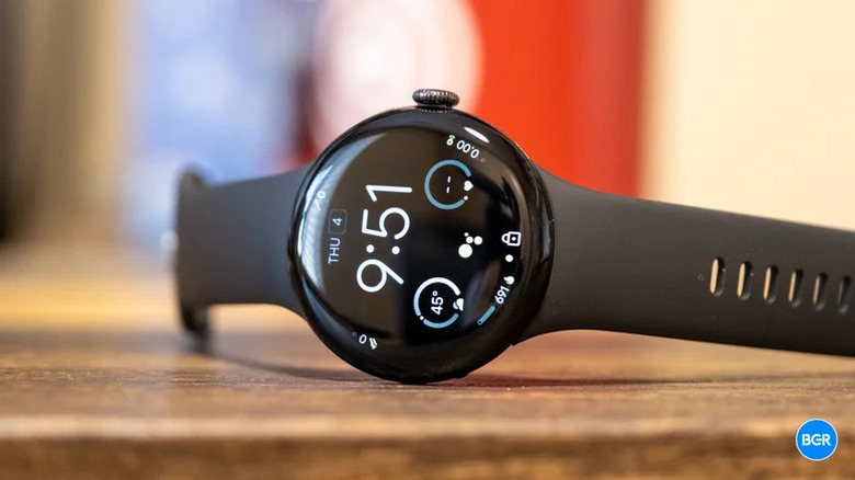 A Google Pixel Watch 4 sideways on a table showing the homescreen.