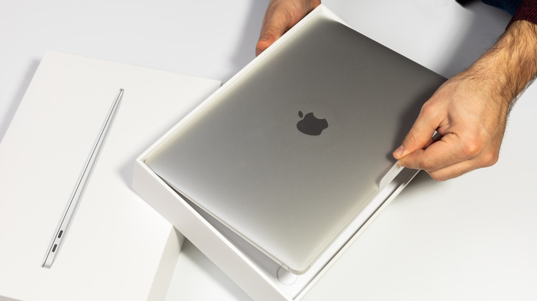 Person unboxing a MacBook Air