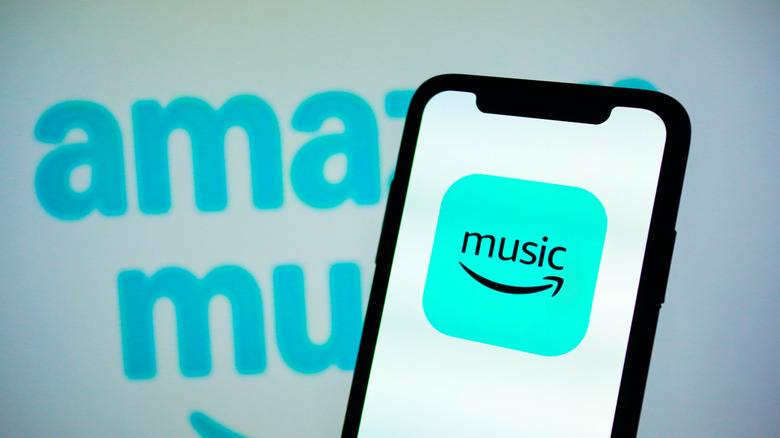 Amazon Music logo on a smartphone and in the background