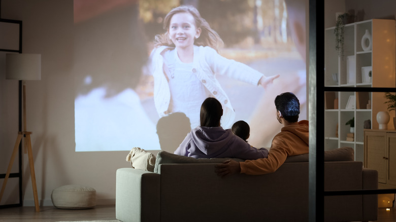 A family watching a movie on a home projector