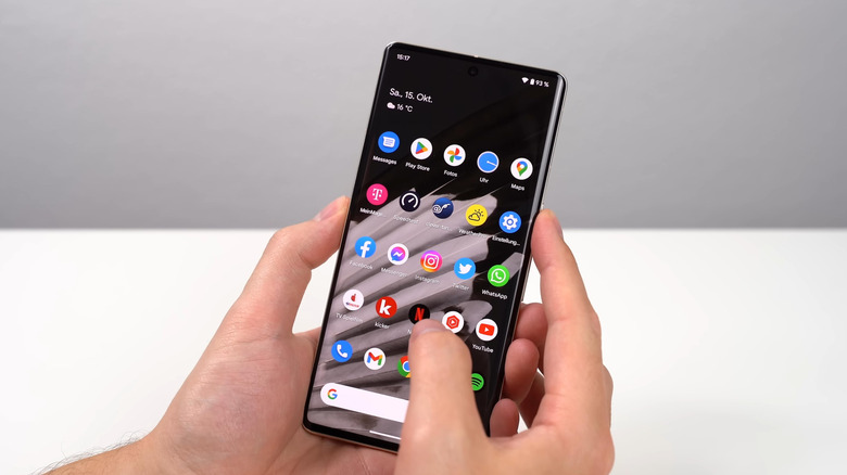 Hands holding and using a Google Pixel 7 Pro smartphone