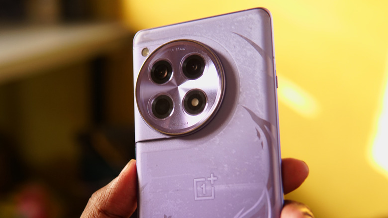 A hand holding a OnePlus 12R smartphone