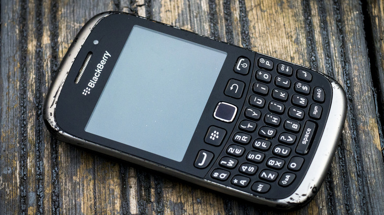 Old BlackBerry phone on wood surface
