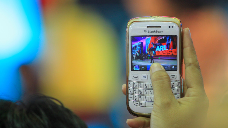 Person taking picture with BlackBerry phone