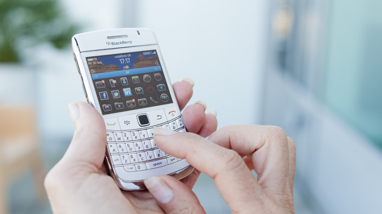 Hands typing on BlackBerry phone