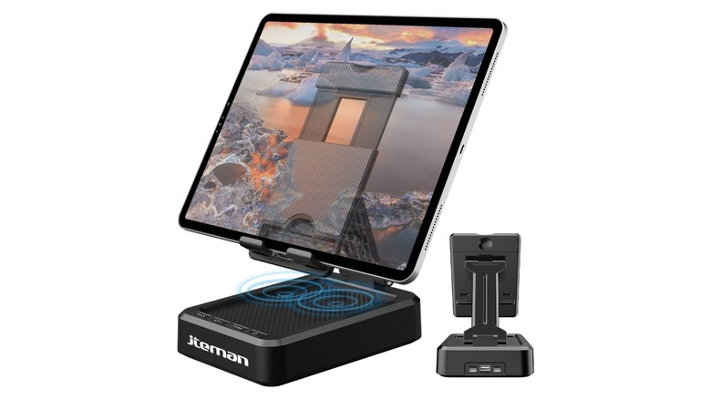 An iPad in a tablet stand with a speaker built into the base