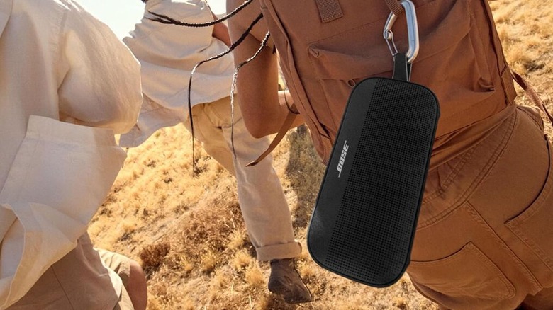 The Bose SoundLink Flex (2nd Gen) attached to a backpack via carabiner.