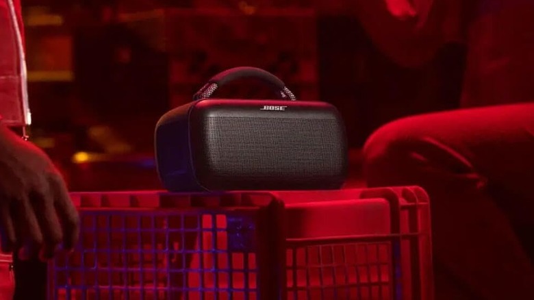 The Bose SoundLink Max in a dark-red room.