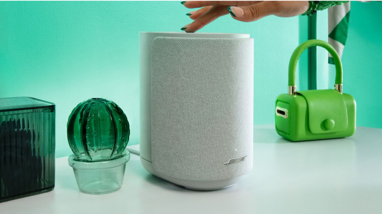 A person interacting with the Bose Lifestyle Ultra Speaker