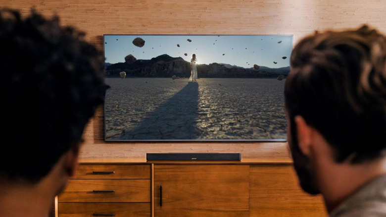 Two men watching a TV with the Bose Smart Soundbar