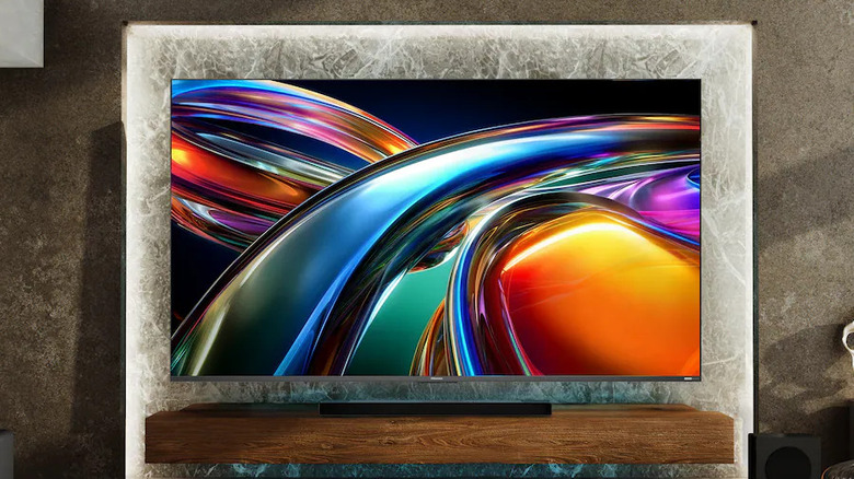 The Hisense UR9SG wall-mounted in a modern living room.