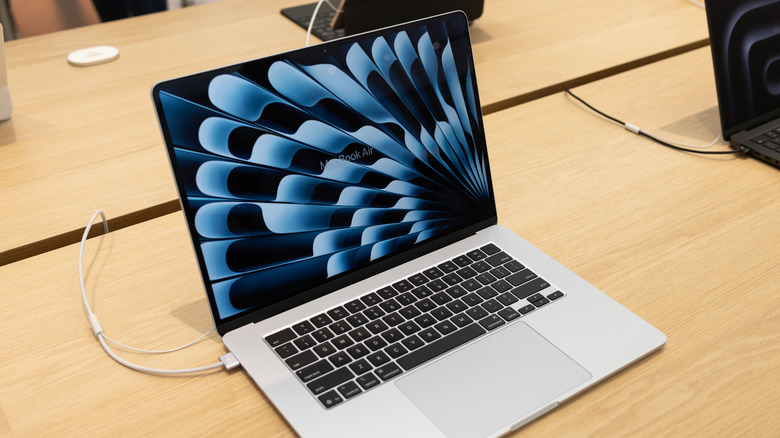 A MacBook Air in an Apple store plugged into a MagSafe charger
