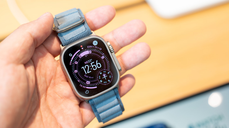 A person holding the Apple Watch Ultra 3 in their hand