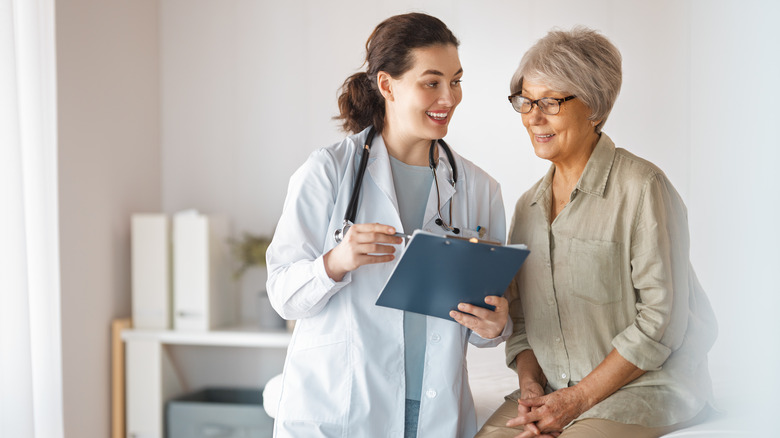 A doctor speaking to an elderly patient