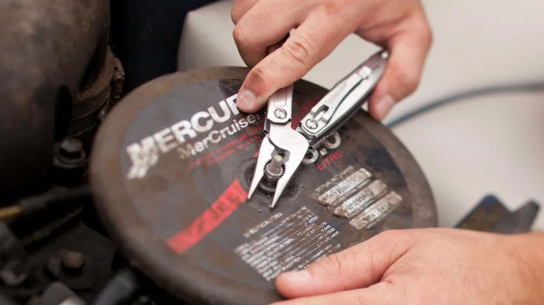 Turning a screw with the Leatherman Sidekick multi-purpose tool.