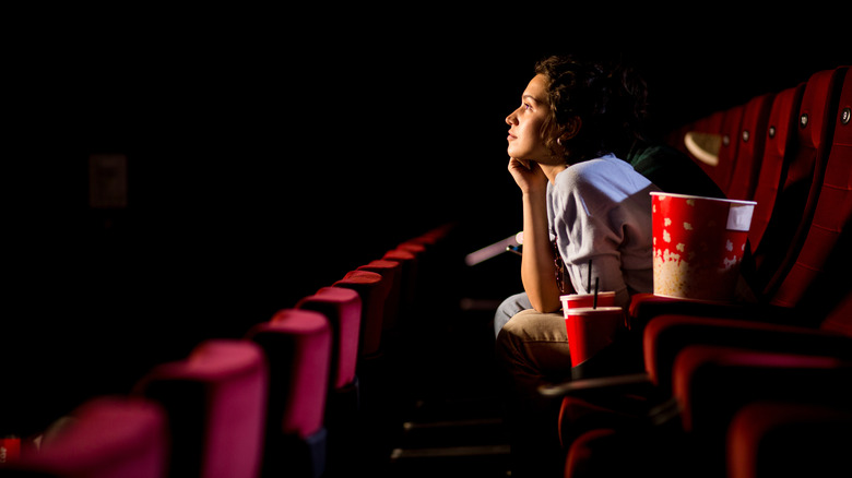 A person watching a movie in a theater.