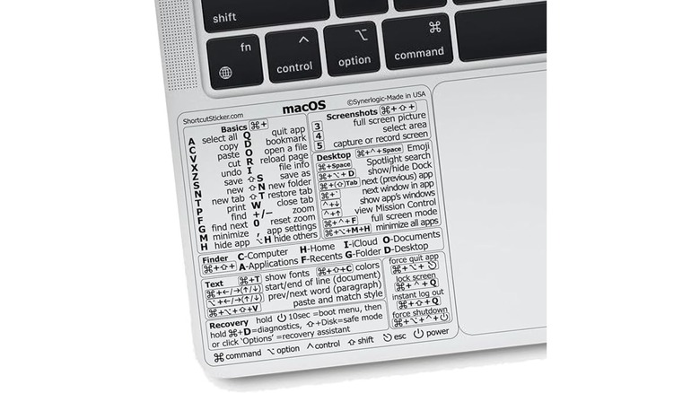 A list of macOS shortcuts presented on a sticker that is applied to the corner of a MacBook